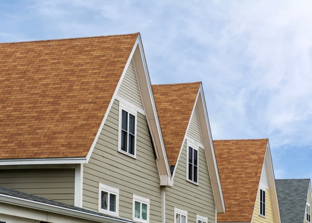 Close-up view of expertly installed gabled roofing on several townhome units, showcasing the durability and standard of a GAF Master Elite Contractor installation.